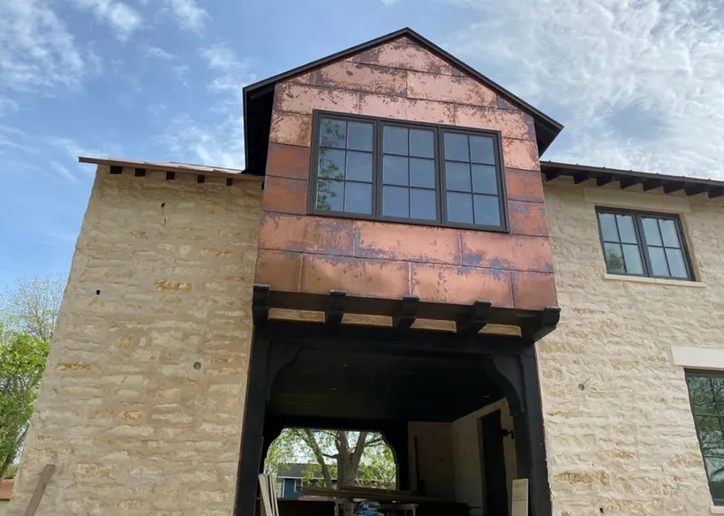 Copper metal panel facade on a stone building for Metal Roof Coating in Allen